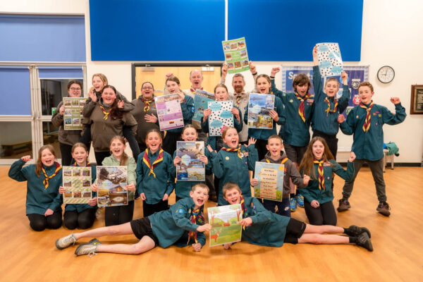 30 scouts and leaders cheering holding their posters about what their town could look like