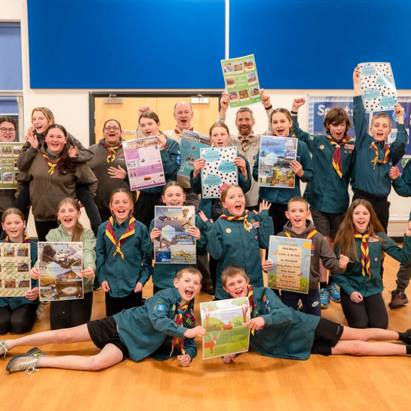 30 scouts and leaders cheering holding their posters about what their town could look like