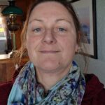 Picture of a lady in a floral scarf and red top