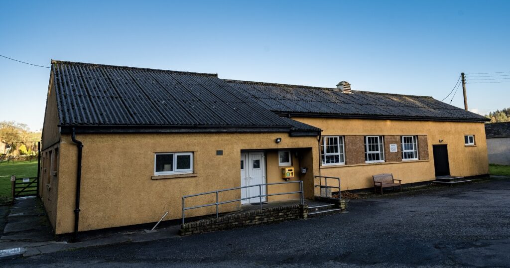 Picture of a single storey mustard coloured community building